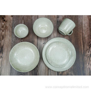 Reactive glazed stoneware dinner set in bluish gray